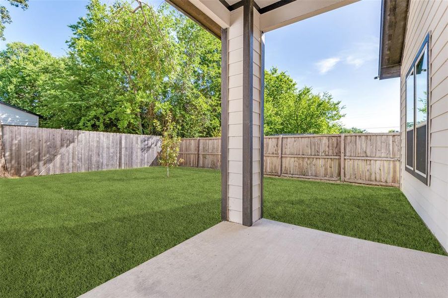 Fenced backyard with a patio