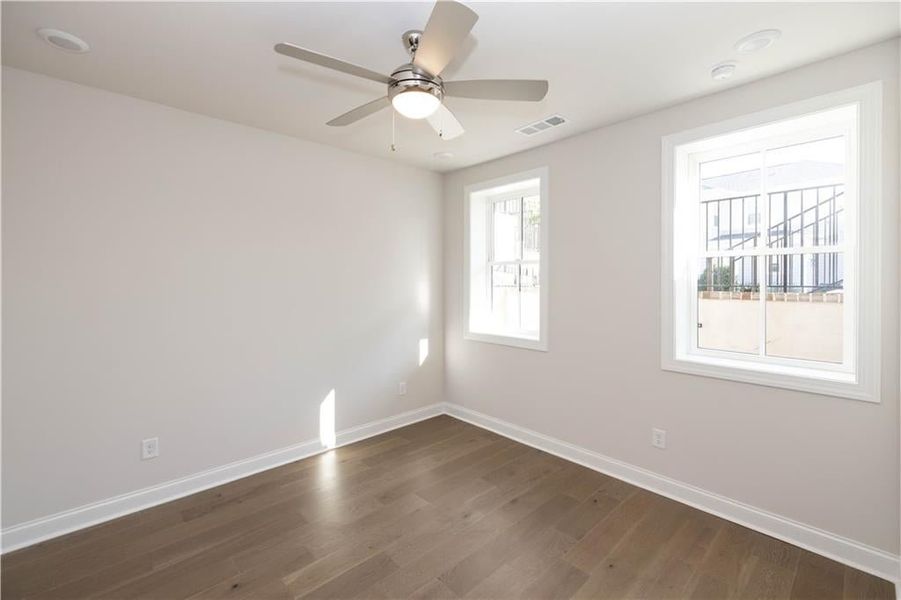 Terrace level bedroom #3 with hard surface flooring, large walk in closet and private ensuite full bathroom with walk in shower. Image is of previously built Chamberlain