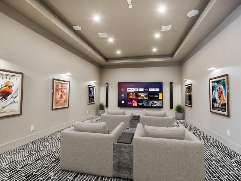 Entertainment space featuring recessed lighting, wall sconces, and a large display screen