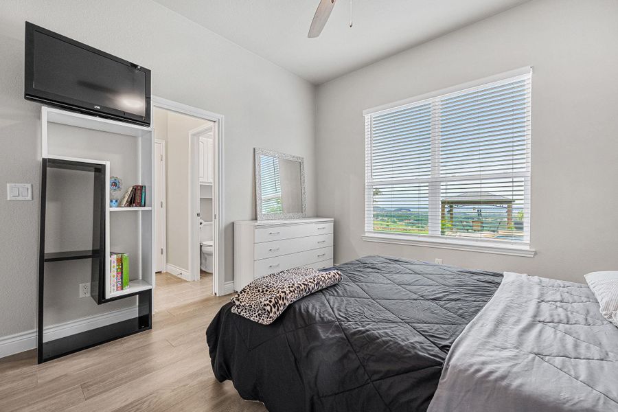 Discover comfort in this bedroom with sleek flooring and ample natural light, offering a clear view of the scenic outdoors. Discover comfort in this bedroom with sleek flooring and ample natural light, offering a clear view of the scenic outdoors.
