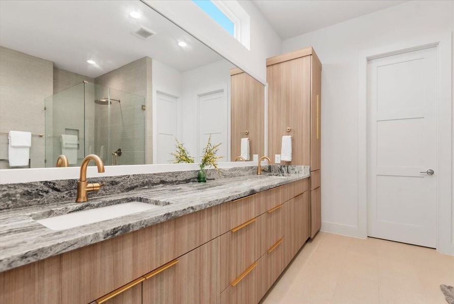 Double sinks, classic mixed metals with a linen closet. Double sinks, classic mixed metals with a linen closet.