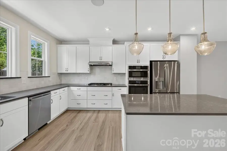 Light filled gourmet kitchen with large island Light filled gourmet kitchen with large island