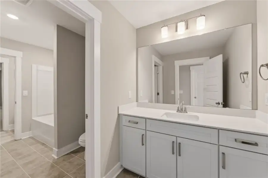 A pristine bathroom features a crisp white vanity A pristine bathroom features a crisp white vanity