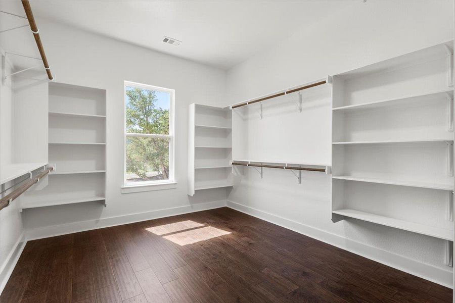 Master Walk in closet featuring dark wood-style flooring Master Walk in closet featuring dark wood-style flooring