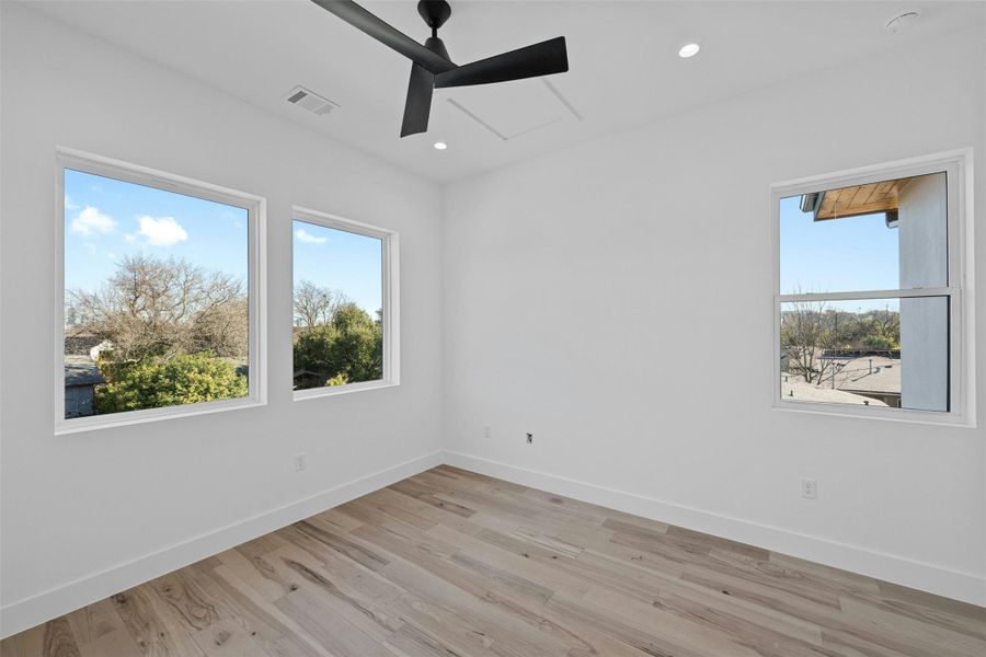 Unfurnished room featuring a ceiling fan, light wood-style floors, and recessed lighting Unfurnished room featuring a ceiling fan, light wood-style floors, and recessed lighting