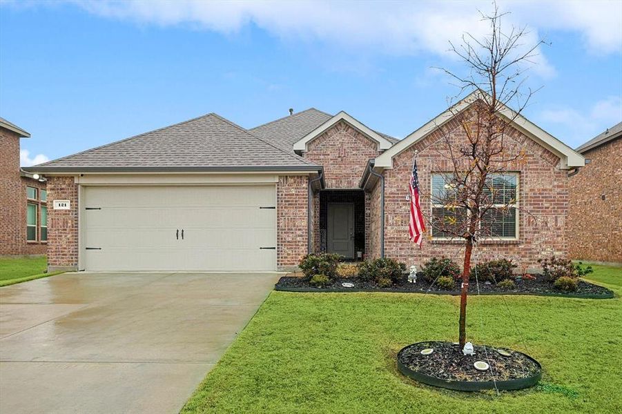 View of front of house with a garage and a front lawn