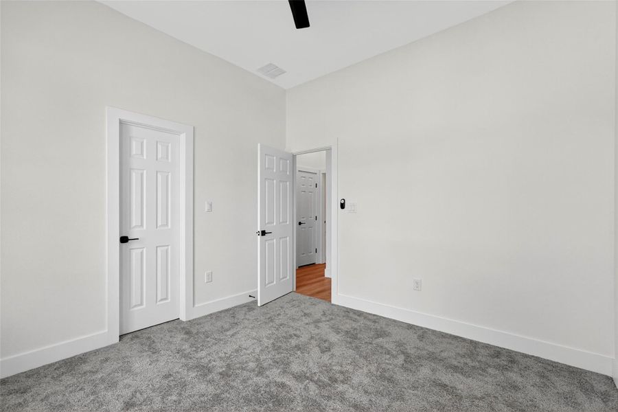 Unfurnished bedroom with carpet and ceiling fan