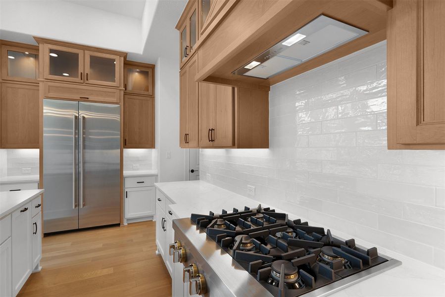 Culinary aspirations ignite in this kitchen, boasting a professional-grade range and rich wood cabinetry.