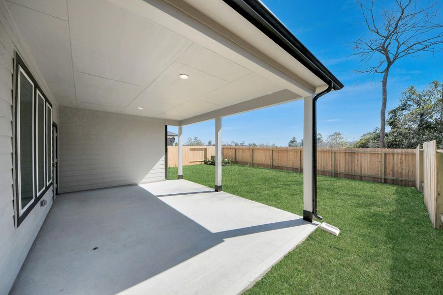 Experience outdoor living at its finest on this expansive covered patio, thoughtfully designed for BBQs and delightful outdoor dining.