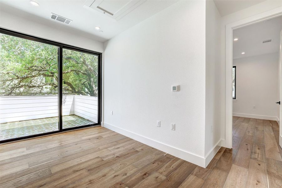 Unfurnished room with light wood-style floors, baseboards, and recessed lighting