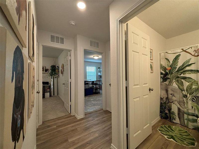 Hallway featuring light wood-style floors