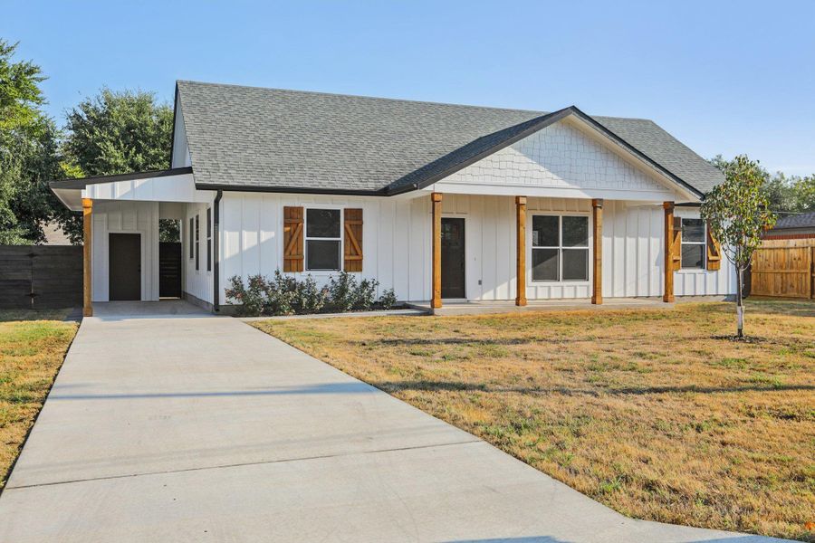 Modern inspired farmhouse with board and batten siding, an attached carport, roof with shingles, driveway, and a porch