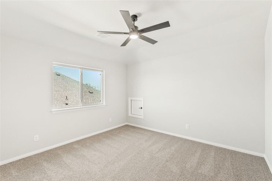 Empty bedroom with carpet flooring, ceiling fan with light, and single window Empty bedroom with carpet flooring, ceiling fan with light, and single window