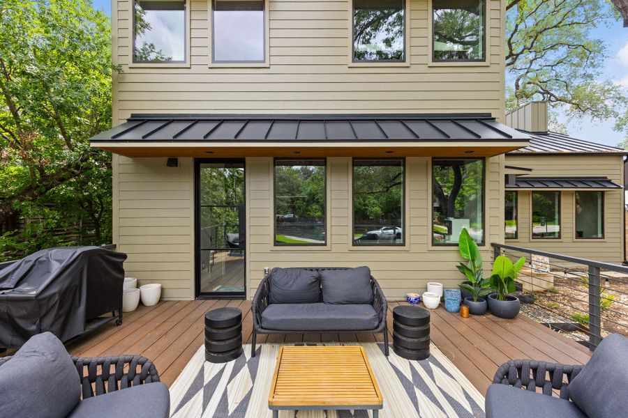 A spacious outdoor deck with wood flooring provides an ideal setting for relaxation and entertaining, complementing the modern house exterior. A spacious outdoor deck with wood flooring provides an ideal setting for relaxation and entertaining, complementing the modern house exterior.