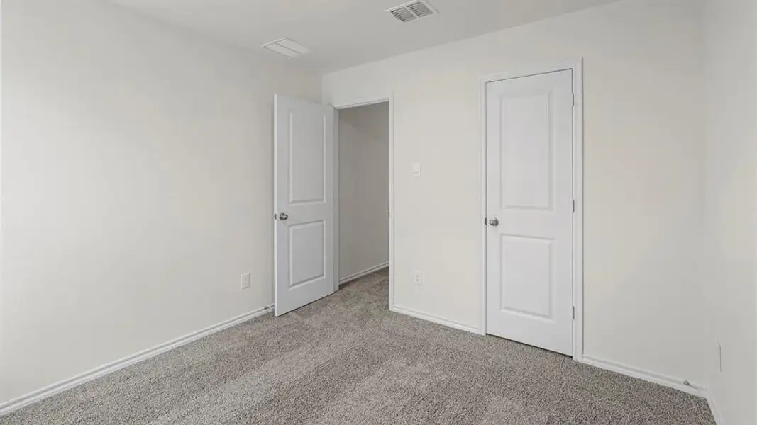 This room features light-colored walls, gray carpet, and white trim
