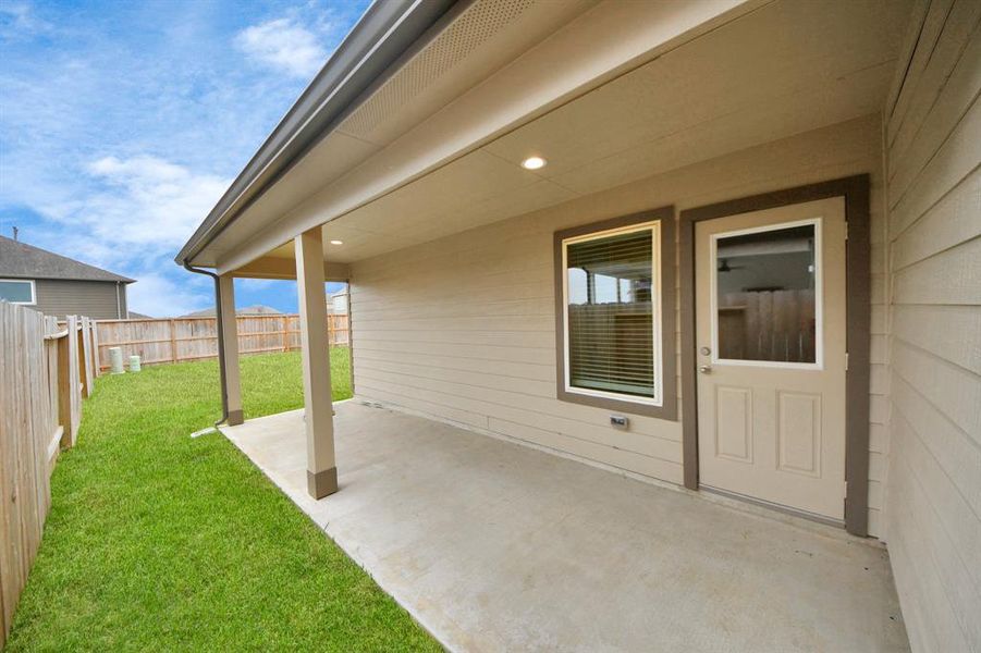 Experience outdoor living at its finest on this expansive covered patio, thoughtfully designed for BBQs and delightful outdoor dining