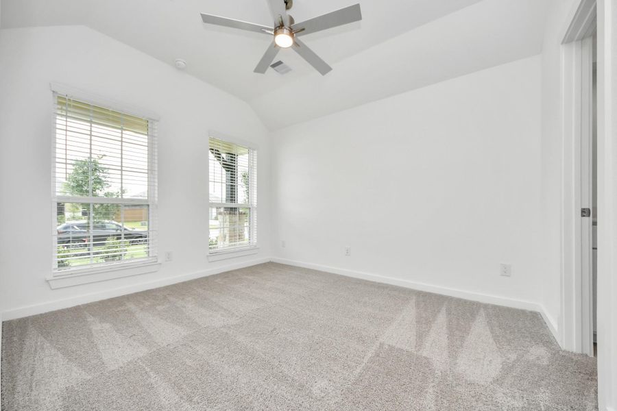 Secondary bedroom features plush carpeting, large windows that let in plenty of natural light, bright paint, and spacious closets. Sample photo of completed home with similar floor plan. Actual colors and selections may vary. Secondary bedroom features plush carpeting, large windows that let in plenty of natural light, bright paint, and spacious closets. Sample photo of completed home with similar floor plan. Actual colors and selections may vary.