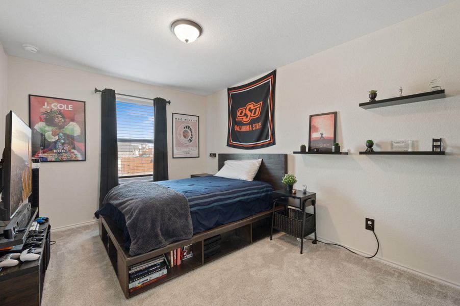 Carpeted bedroom with baseboards