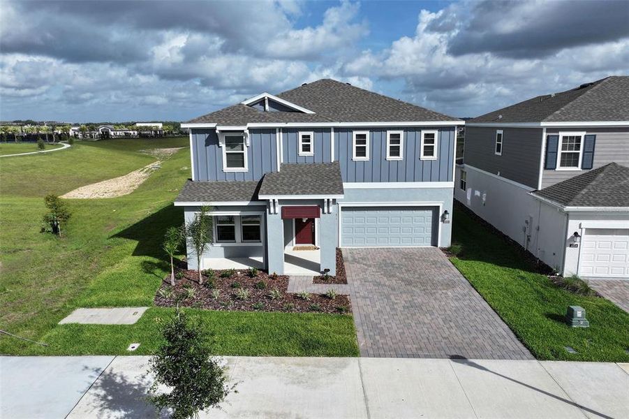 Front exterior of a new home in Wellness Ridge, Clermont, FL, highlighting curb appeal (Image 30).