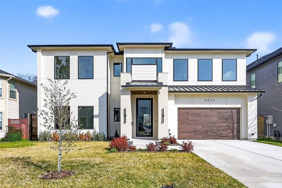 Inviting front walkway with fresh landscaping and bold architectural details.