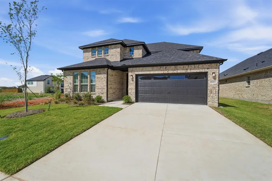 Front exterior of a new home in Green Meadows, Celina, TX, highlighting curb appeal (Image 27). Front exterior of a new home in Green Meadows, Celina, TX, highlighting curb appeal (Image 27).
