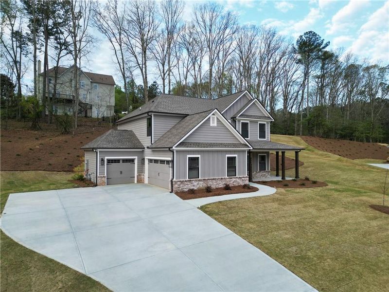 Front exterior of a new home in Red Oak Ridge, Loganville, GA, highlighting curb appeal (Image 22). Front exterior of a new home in Red Oak Ridge, Loganville, GA, highlighting curb appeal (Image 22).