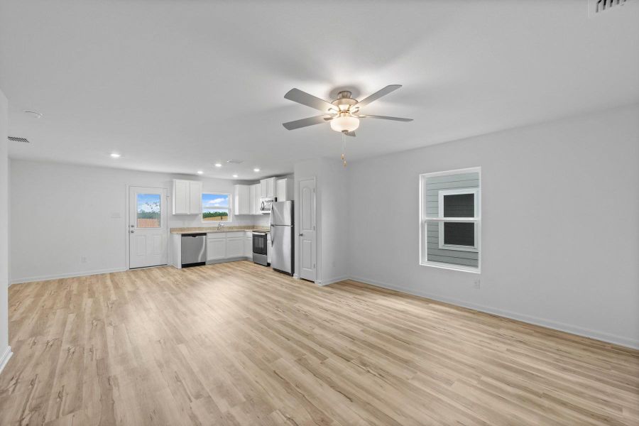 Unfurnished living room with light wood-style floors, recessed lighting, and ceiling fan
