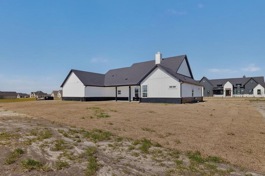 Rear view of house with a chimney and a residential view