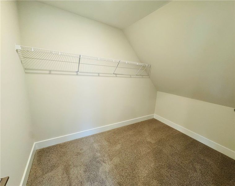 This carpeted space offers practical storage solut