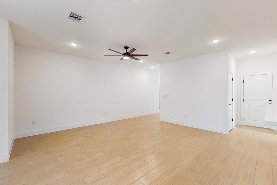 Spare room with light wood finished floors, recessed lighting, and a ceiling fan