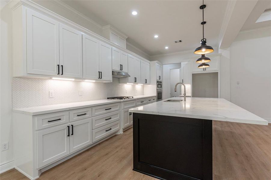 Under cabinet lighting is just another detail the has builder added to this modern kitchen.