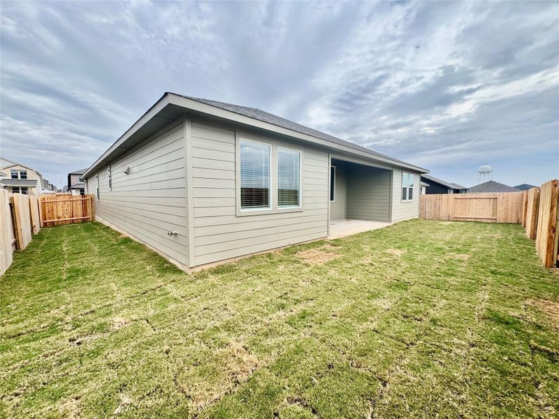 Rear view of house with a fenced backyard and a patio Rear view of house with a fenced backyard and a patio