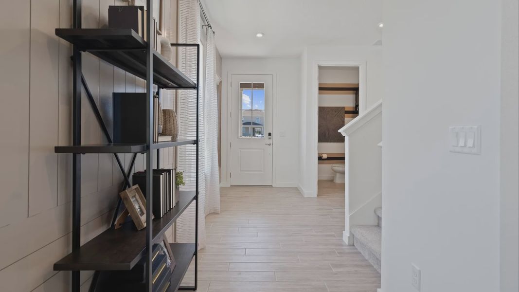 Entry hallway and powder room in a DRB Home Clementine model at the Trinity Place community.