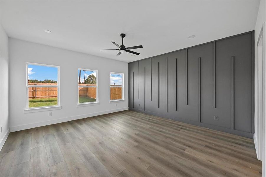 Unfurnished room featuring ceiling fan and hardwood / wood-style floors