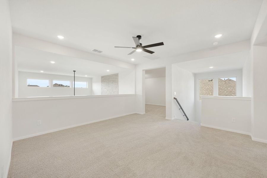 Spacious upstairs bonus room with carpet, ceiling fan, recessed lighting, and staircase opening. Spacious upstairs bonus room with carpet, ceiling fan, recessed lighting, and staircase opening.