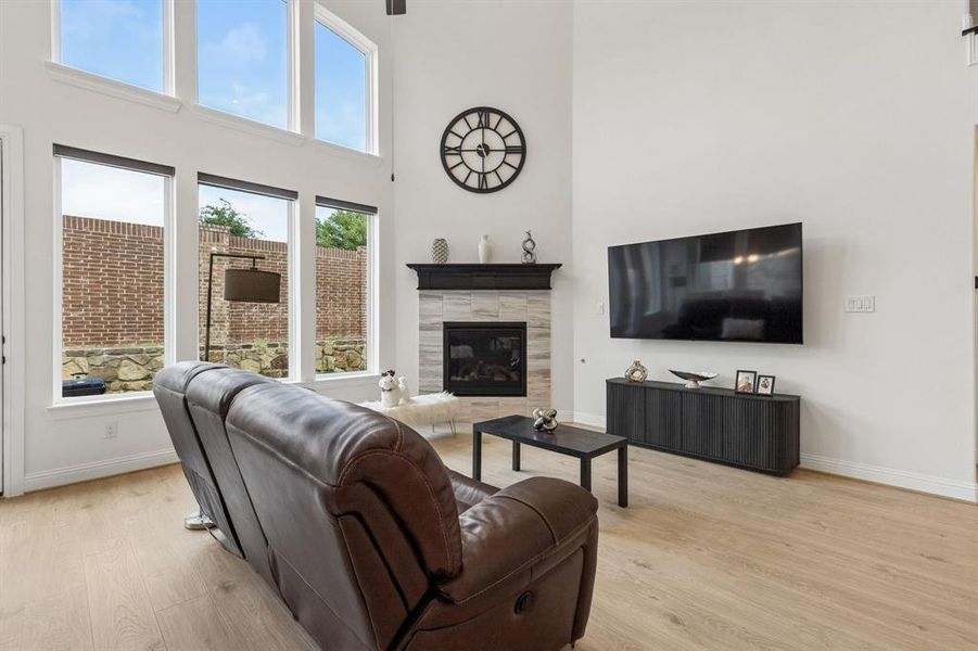 Living room with soaring ceilings and abundant natural light from upper and lower windows