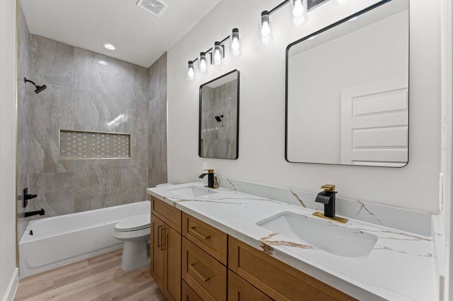 The 2nd bathroom also includes double vanities, and a tub/shower combination tiled to the ceiling with gorgeous 24"x24" porcelain.