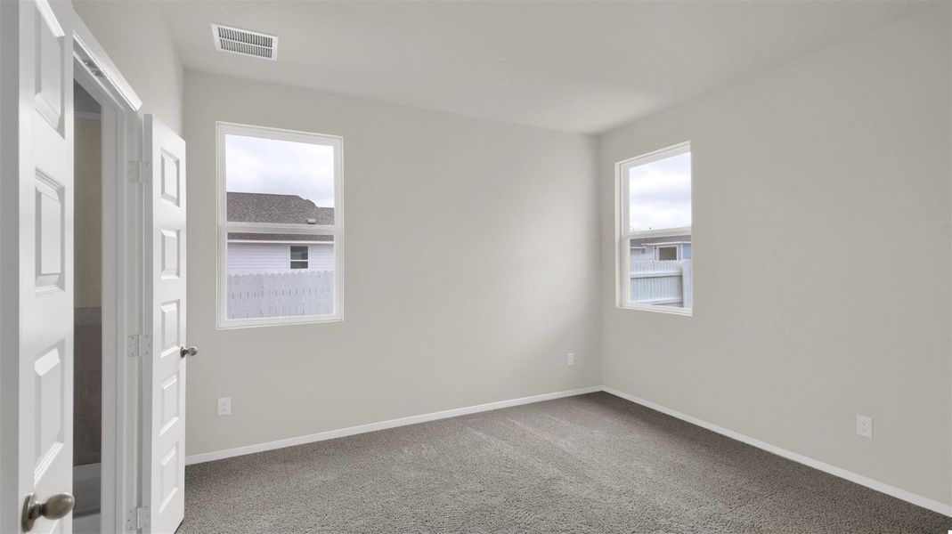 Carpeted empty room featuring baseboards