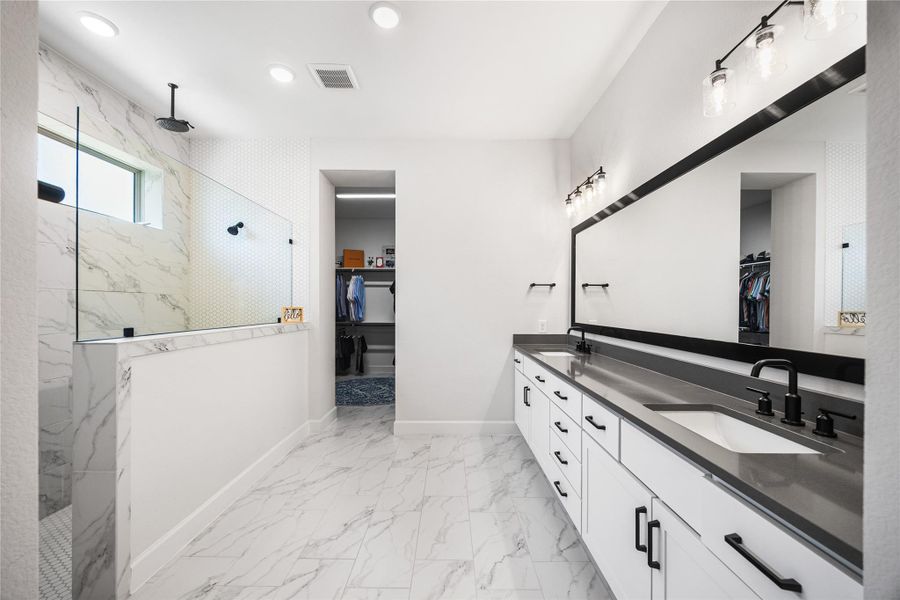 Luxurious primary bath featuring an oversized walk-in shower with a ceiling-mounted rainfall showerhead.