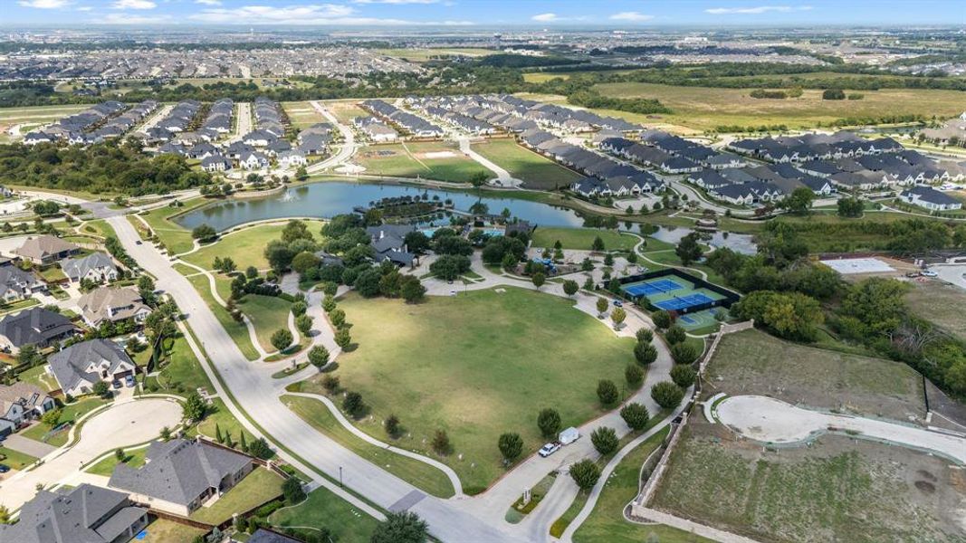 Aerial view of property's location with a large body of water and nearby suburban area