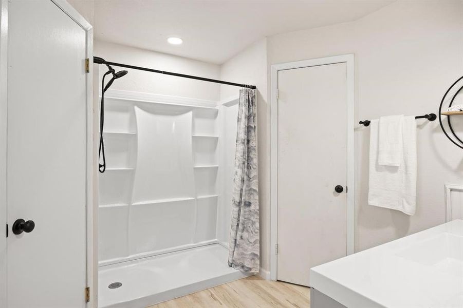 Bathroom featuring vanity, a shower with curtain, and hardwood / wood-style floors