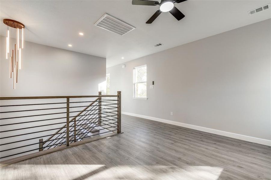 Empty room featuring wood-type flooring and ceiling fan