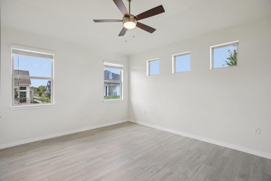 Empty room featuring light wood-type flooring and ceiling fan