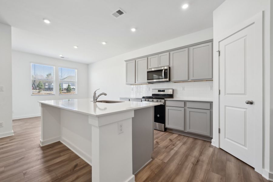 A kitchen with white cabinets. A kitchen with white cabinets.