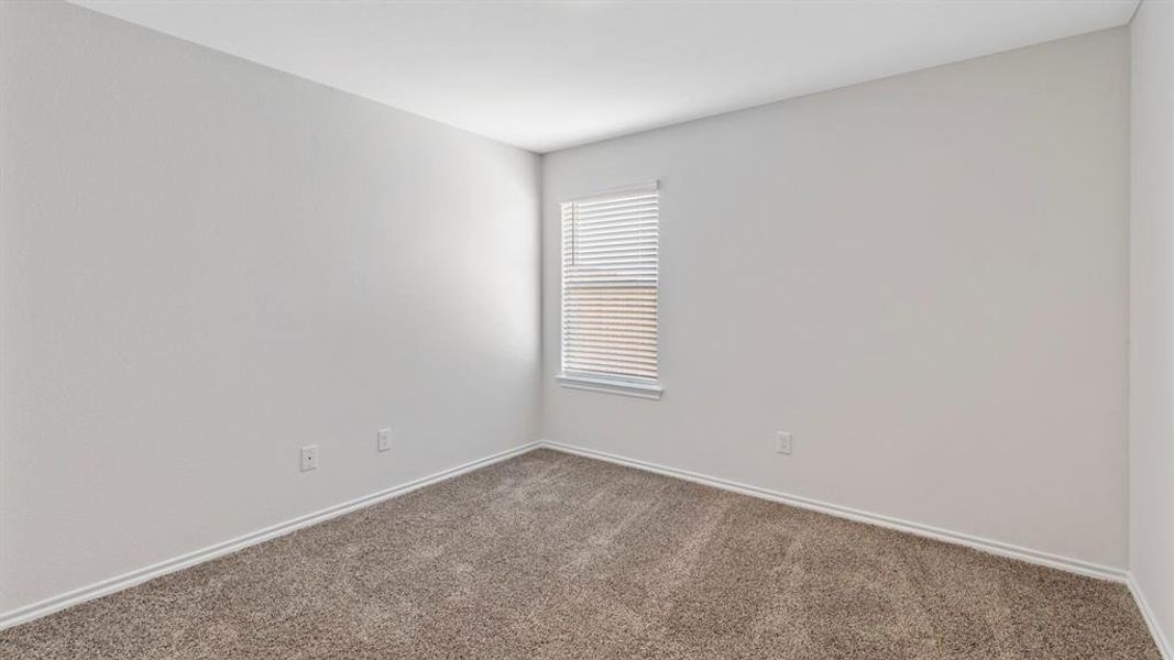 Carpeted empty room with baseboards