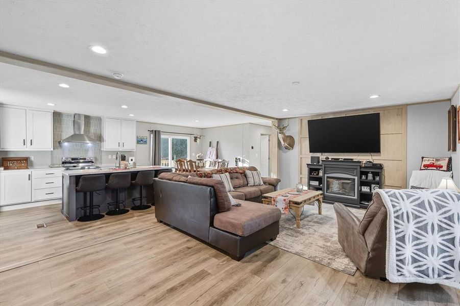 Living area with recessed lighting and light wood finished floors Living area with recessed lighting and light wood finished floors