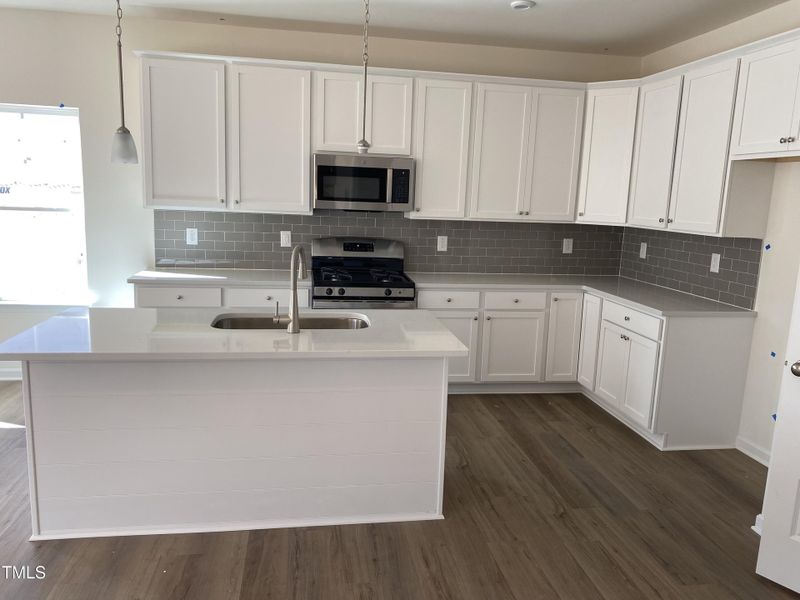 Kitchen with Quartz and Taupe backsplash