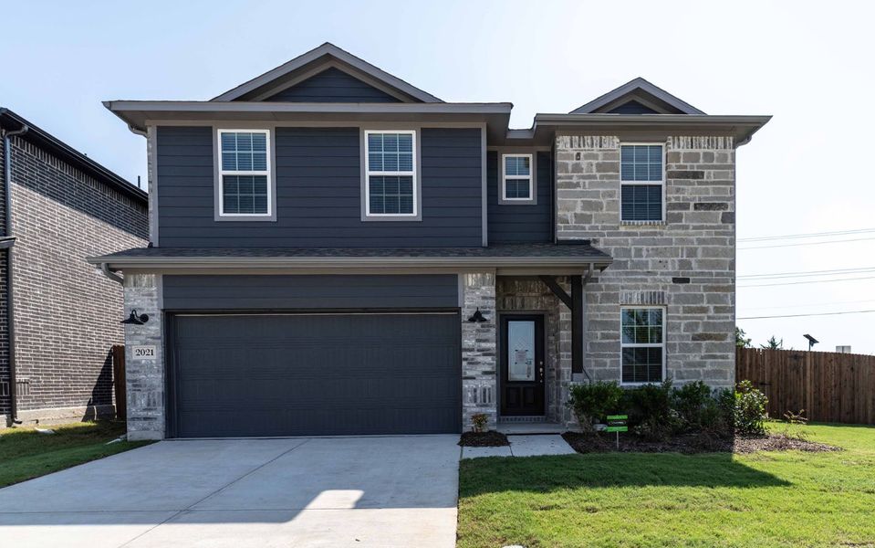 Front exterior of a new home in Travis Ranch, Forney, TX, highlighting curb appeal (Image 1). Front exterior of a new home in Travis Ranch, Forney, TX, highlighting curb appeal (Image 1).