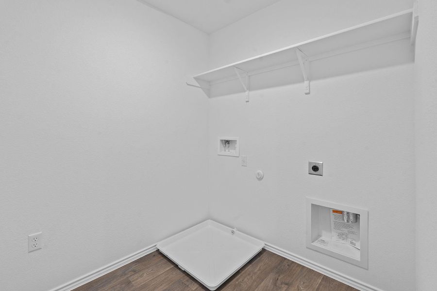 Washroom featuring hookup for a gas dryer, dark wood-style flooring, electric dryer hookup, and washer hookup Washroom featuring hookup for a gas dryer, dark wood-style flooring, electric dryer hookup, and washer hookup