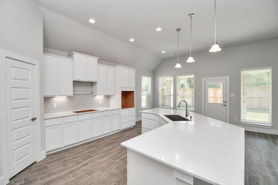 Culinary haven, featuring granite countertops, a tile backsplash, stainless steel appliances (to be installed), and 42” upper cabinets. Sample photo of completed home with similar floor plan. Actual colors and selections may vary. Culinary haven, featuring granite countertops, a tile backsplash, stainless steel appliances (to be installed), and 42” upper cabinets. Sample photo of completed home with similar floor plan. Actual colors and selections may vary.